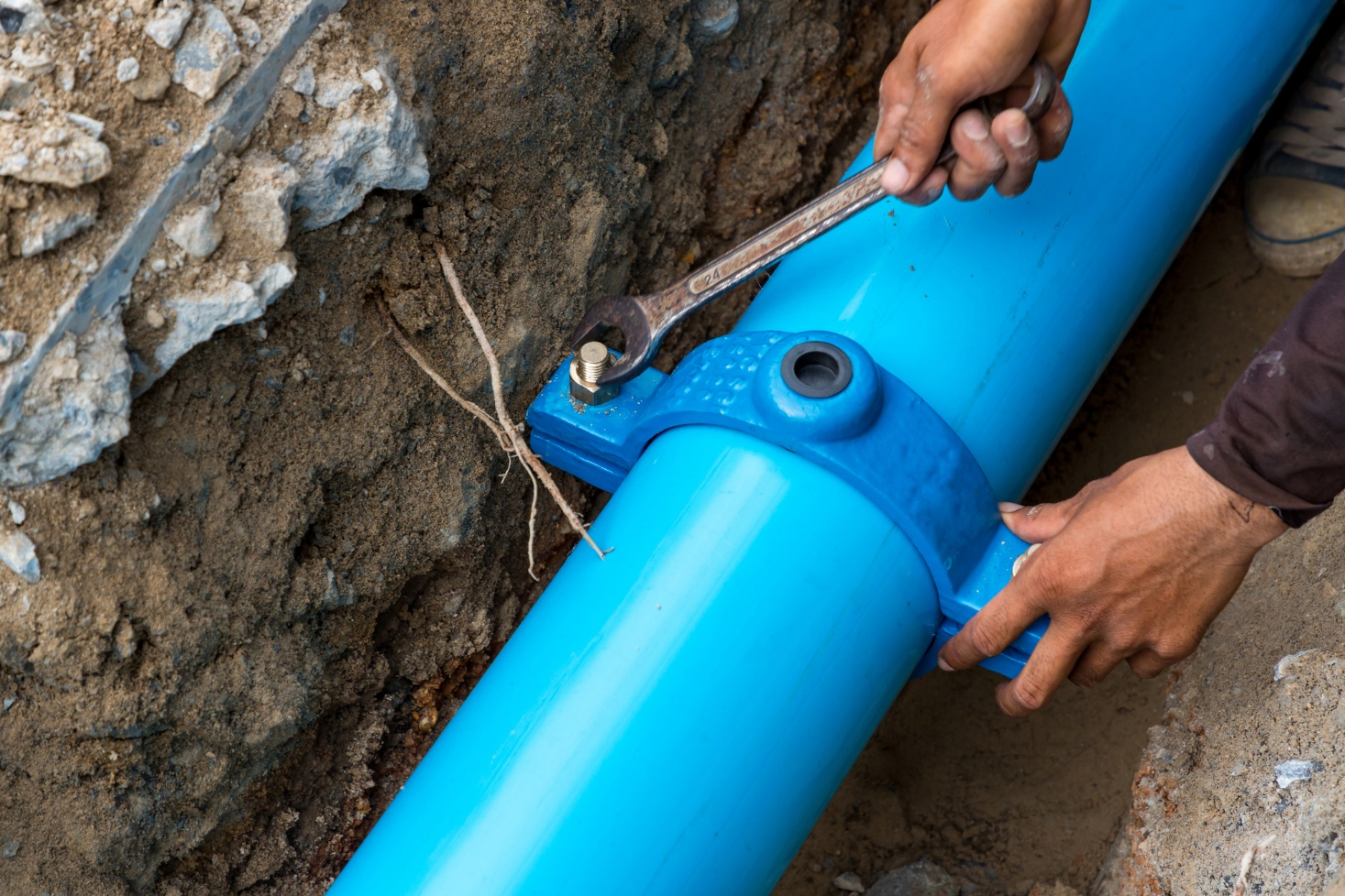 A person fixing a sewer line