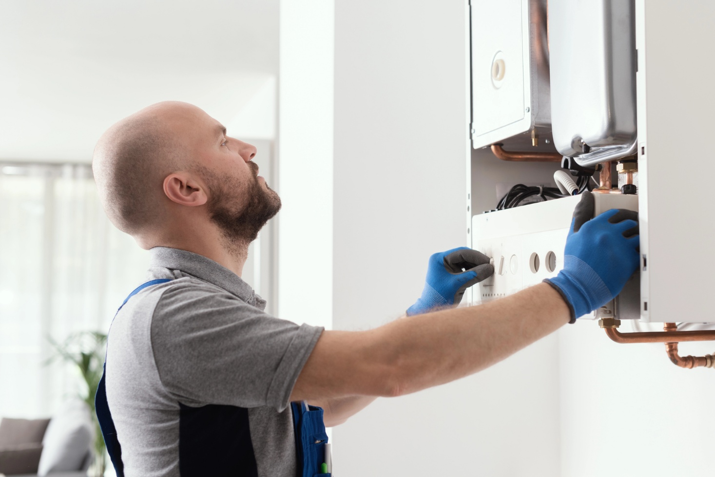 A plumber tests a gas boiler after repair